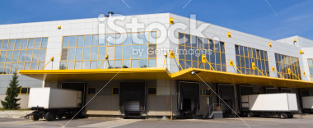 Loading docks with multiple trailers in building covered in windows