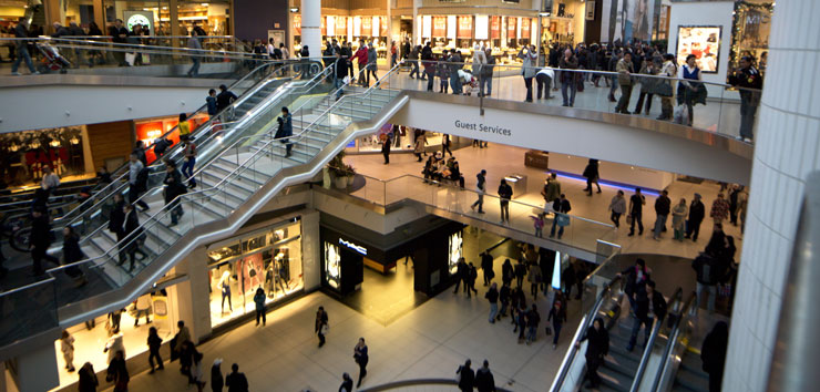 Crowded mall with stairs, escalator and three levels