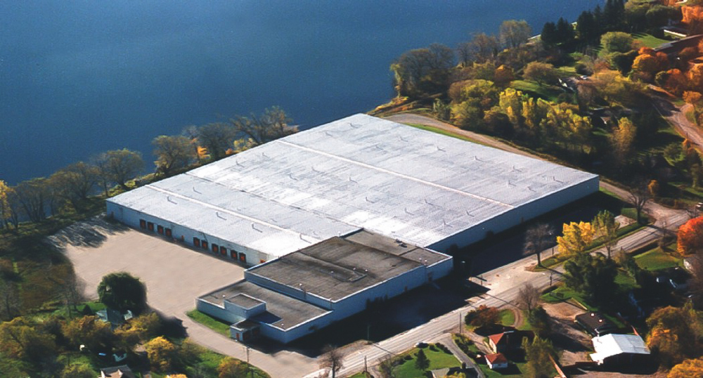 Birds eye view of All Can's warehouse beside the water
