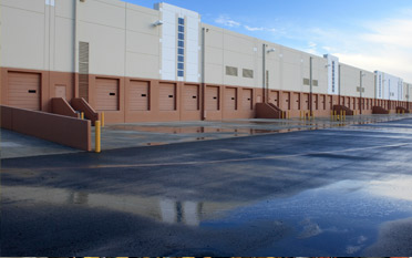 Parking lot and rows of loading docks behind building